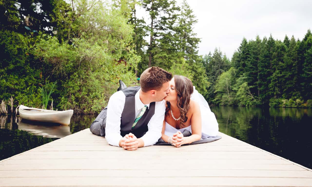 couple-getting-married-on-lodge-deck-with-sunset