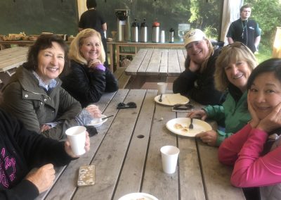 Women on picnic table at Lakedales San Juan Island campsite