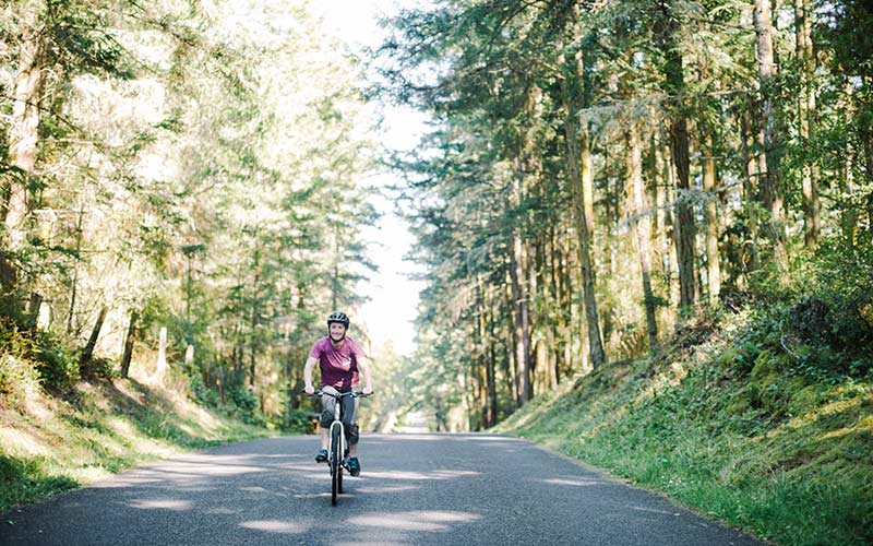 Discovery Adventures biking in forest on San Juan Island