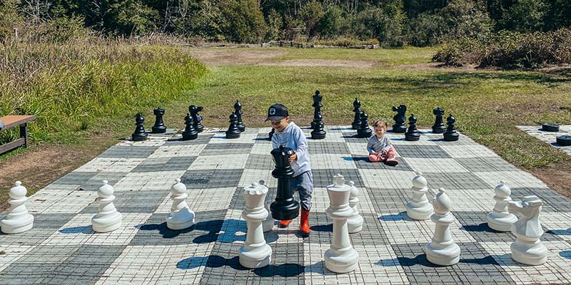 kids playing giant chess at Lakedale on San Juan Island